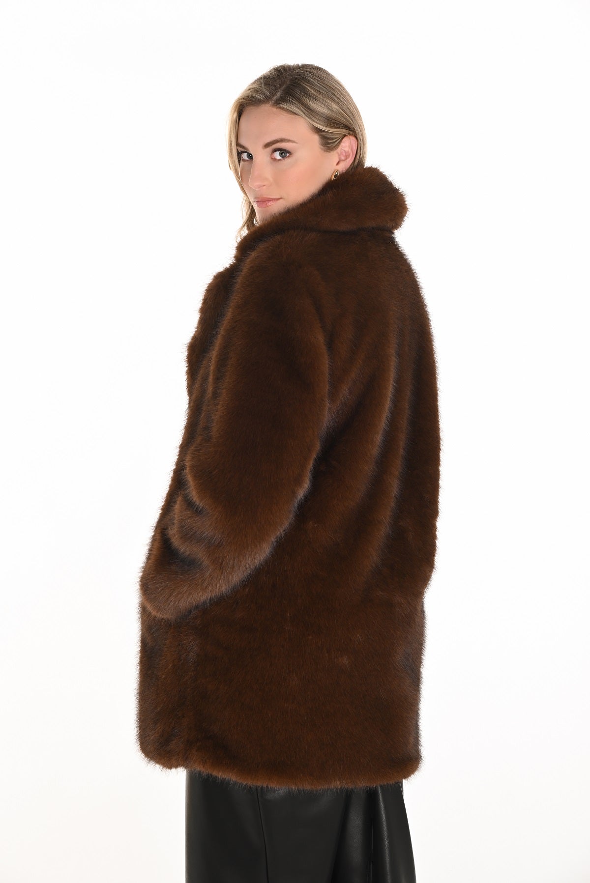 Woman wearing a brown fur coat on a white background