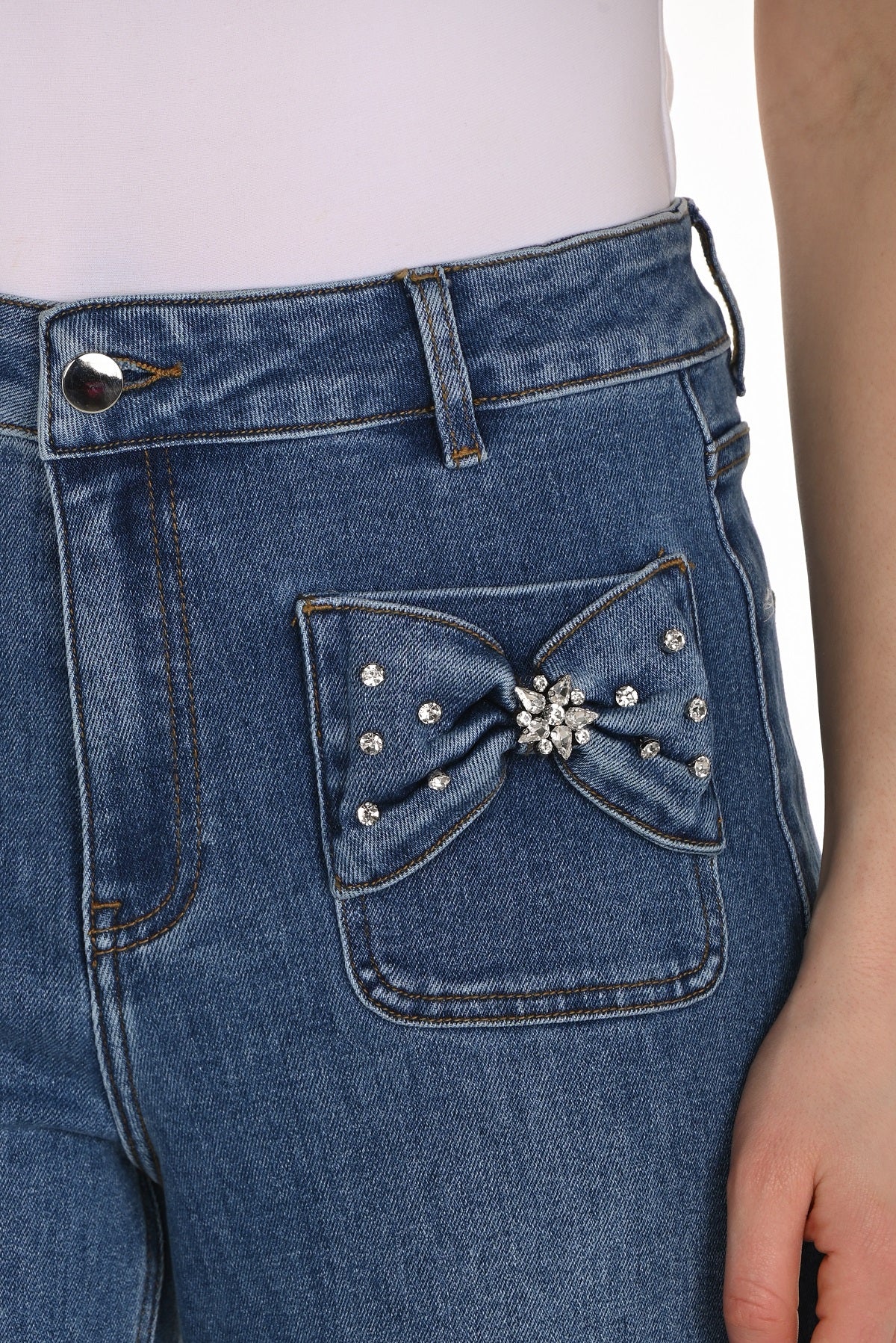 High rise blue jeans with striking crystal stone bow detail in full length with wide leg