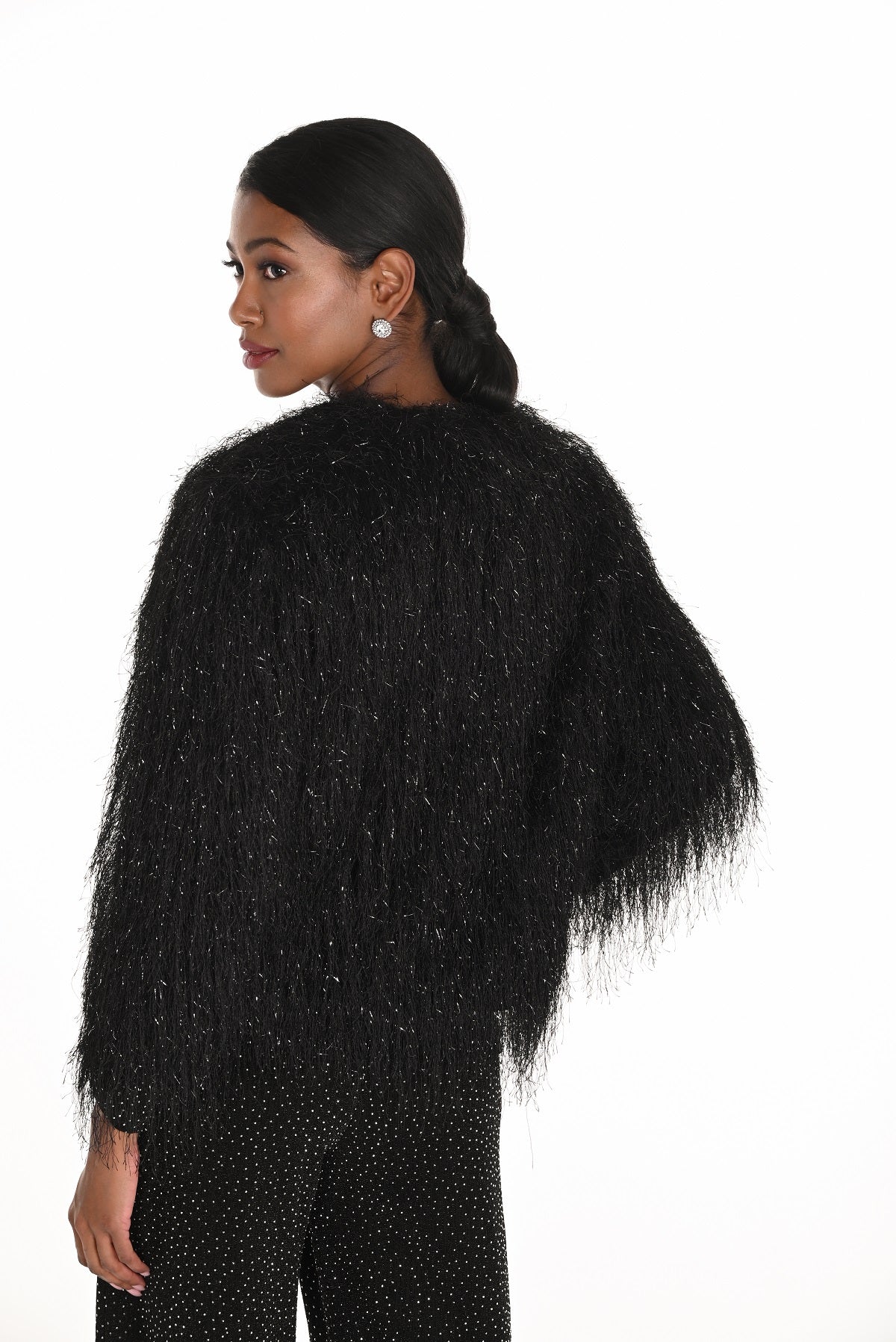 Woman wearing a black textured sweater on a white background