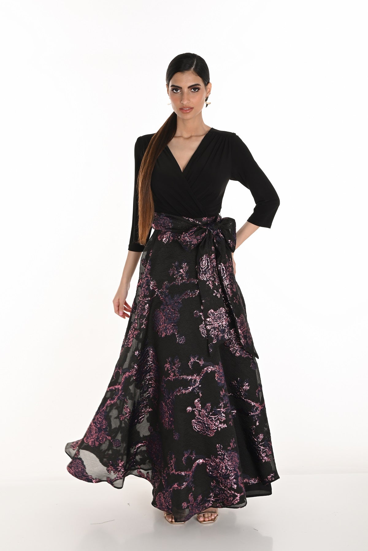 Woman wearing a black and purple floral dress on a white background