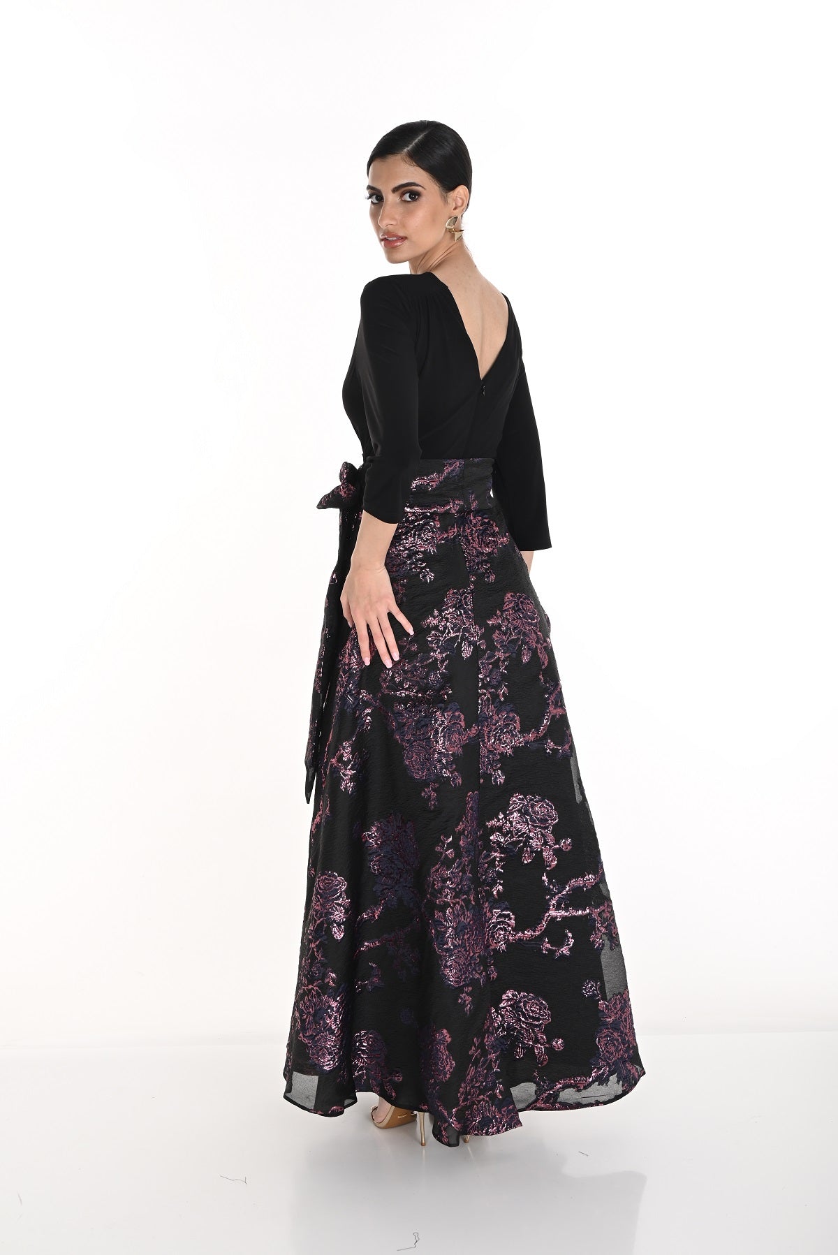 Woman wearing a black and purple floral dress on a white background