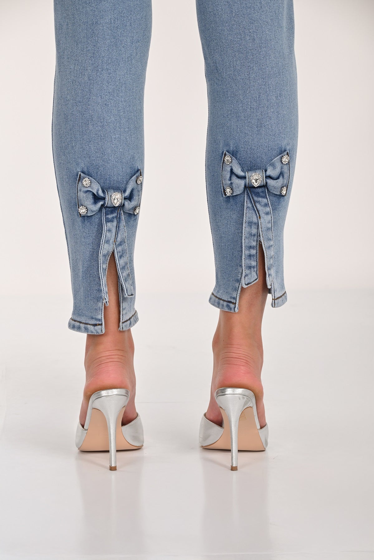 Slim Silhouette Jeans with Back Crystal Bow Detail. Frank Lyman Style 261625