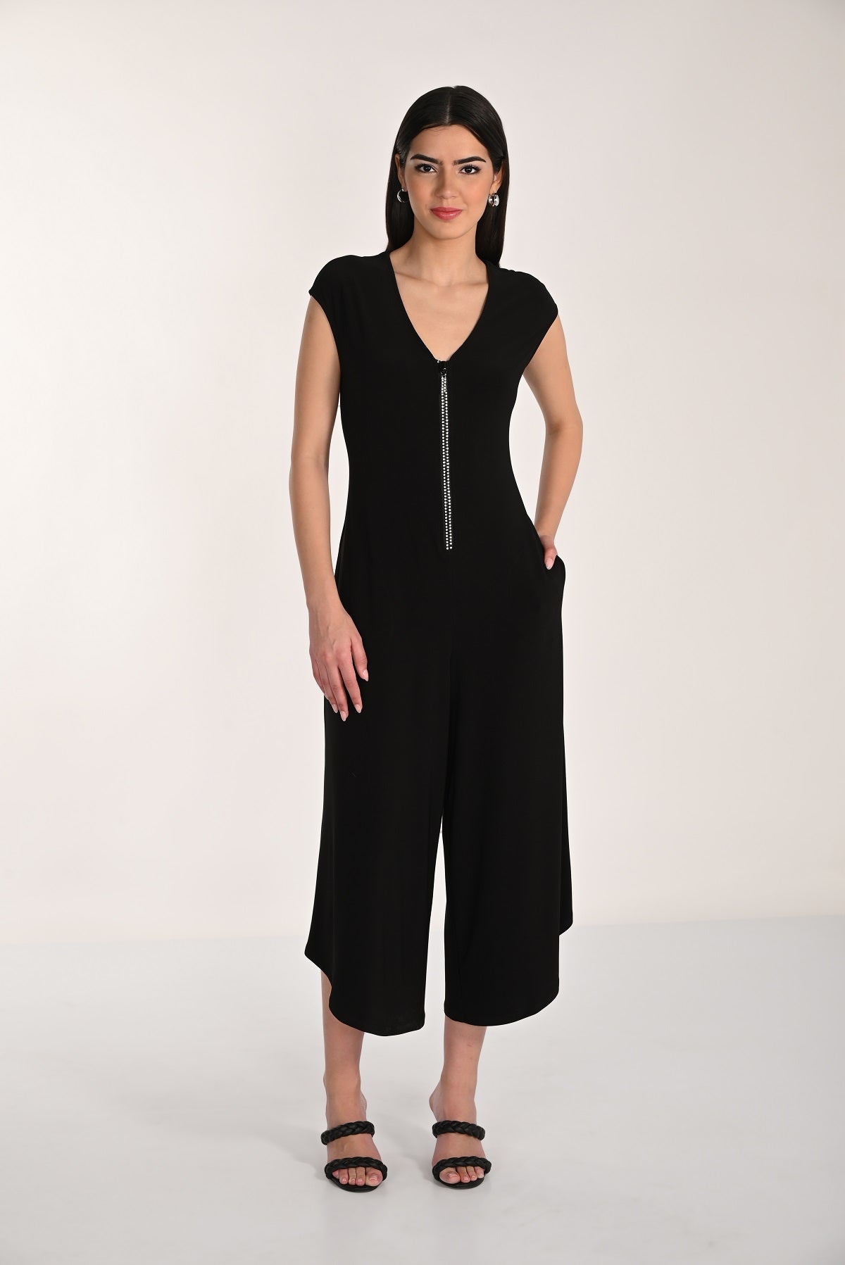 Black cap sleeve knit jumpsuit with wide leg and embellished front zipper