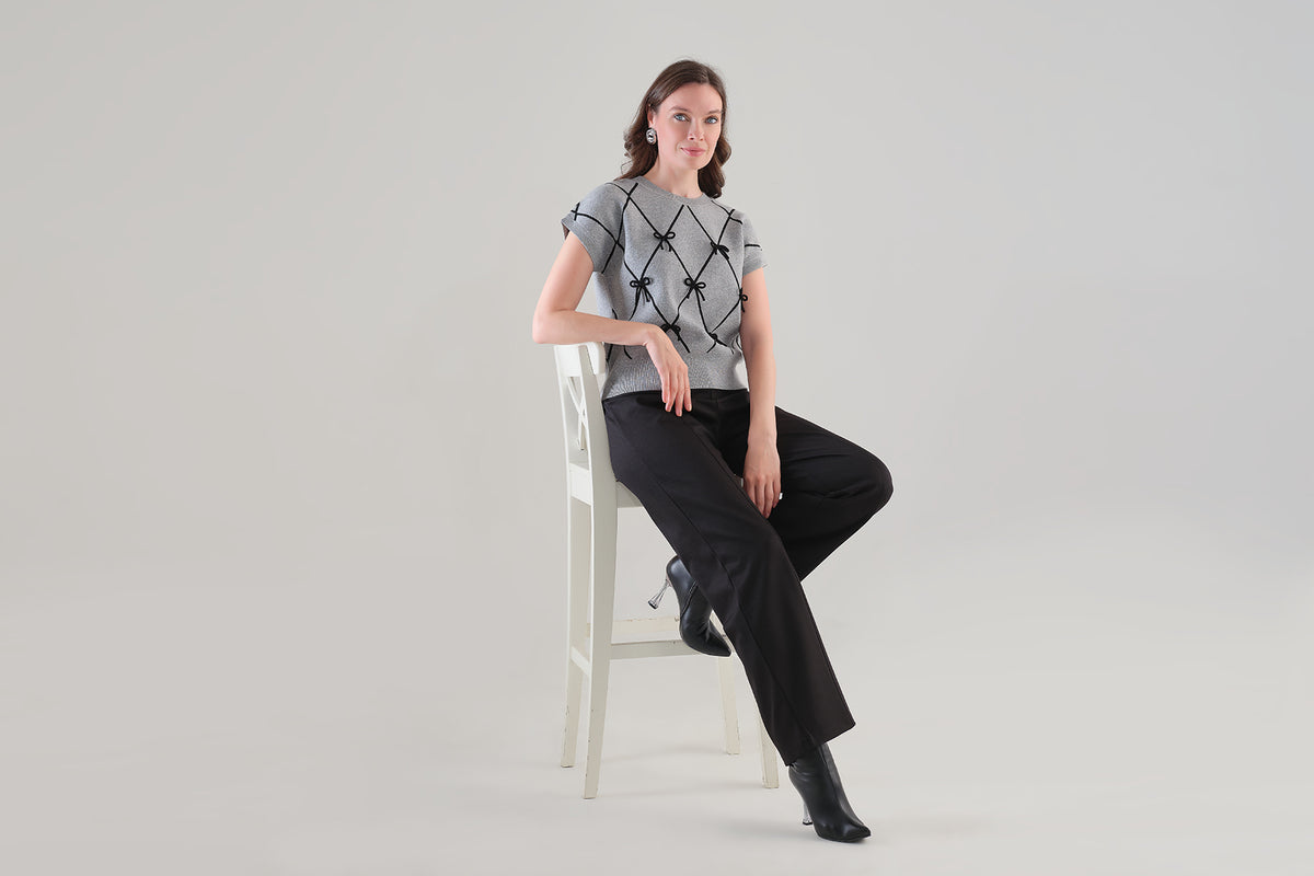 Fashionable cropped length sweater with front bow detail. Tricotto 96210