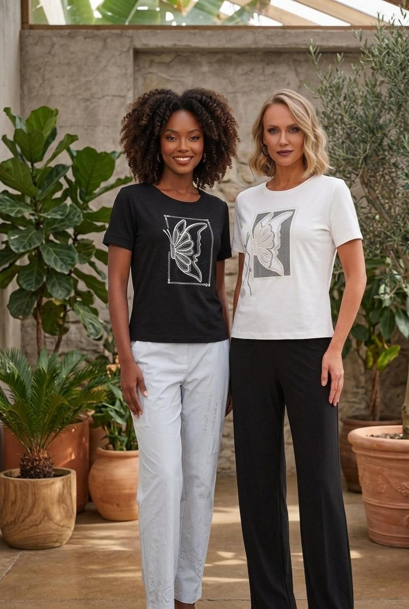 Two women standing outdoors with plants in the background