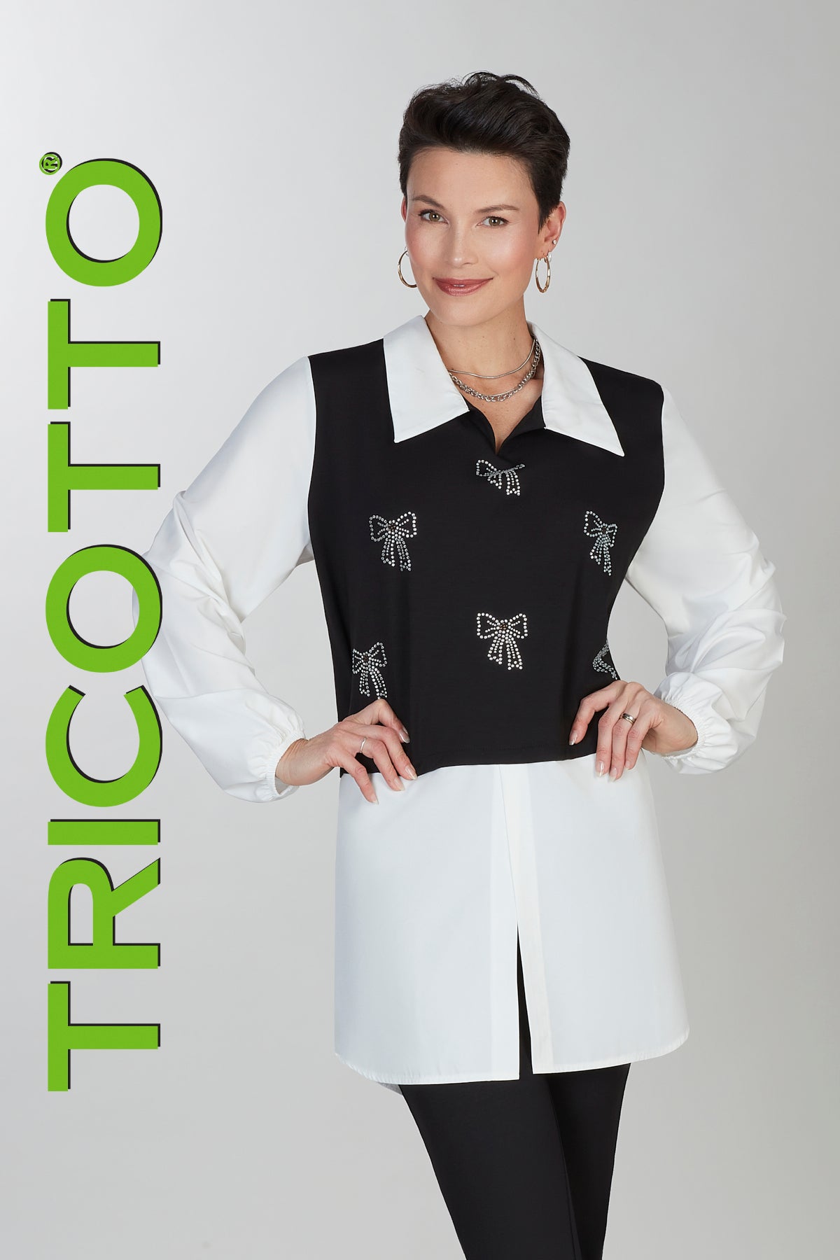 Woman wearing a black vest with white bow patterns and a white blouse, with 'Tricotto' branding on a gray background.