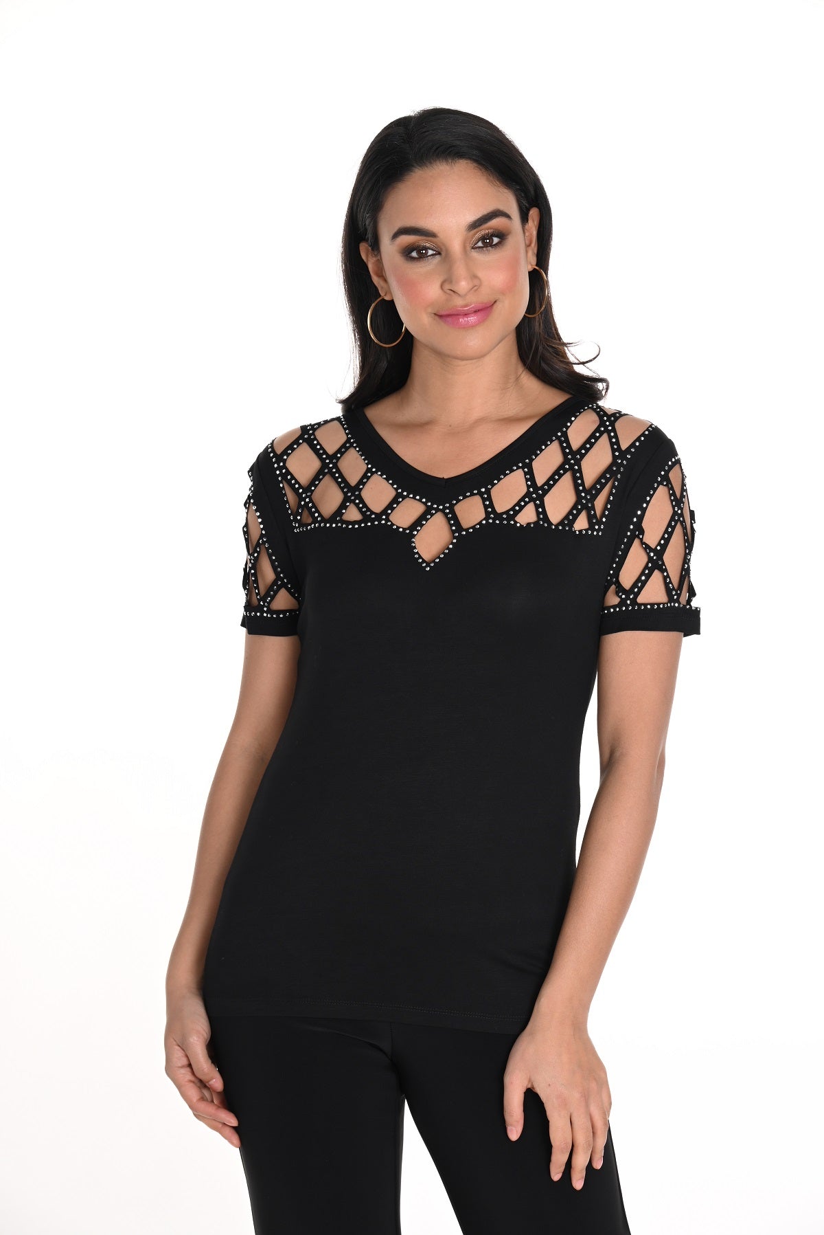 Woman wearing a black top with lace details on a white background