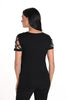 Woman wearing a black outfit with lace sleeves on a white background