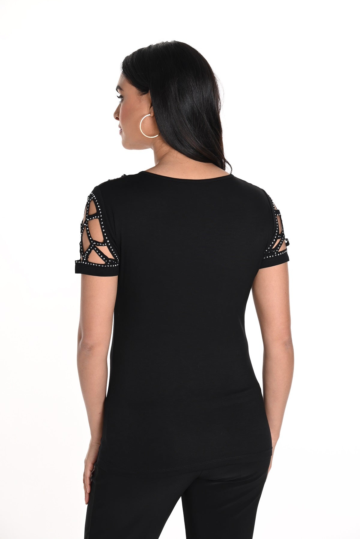 Woman wearing a black outfit with lace sleeves on a white background