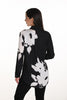 Woman wearing a black and white floral patterned shirt on a white background