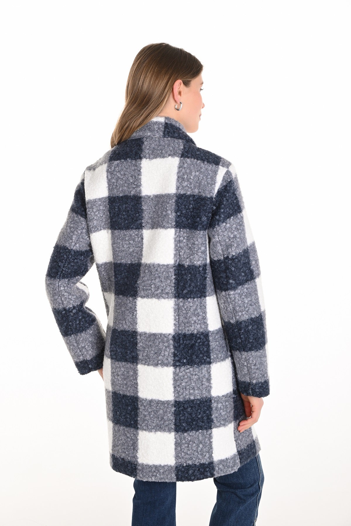 Person wearing a blue and white checkered coat on a white background