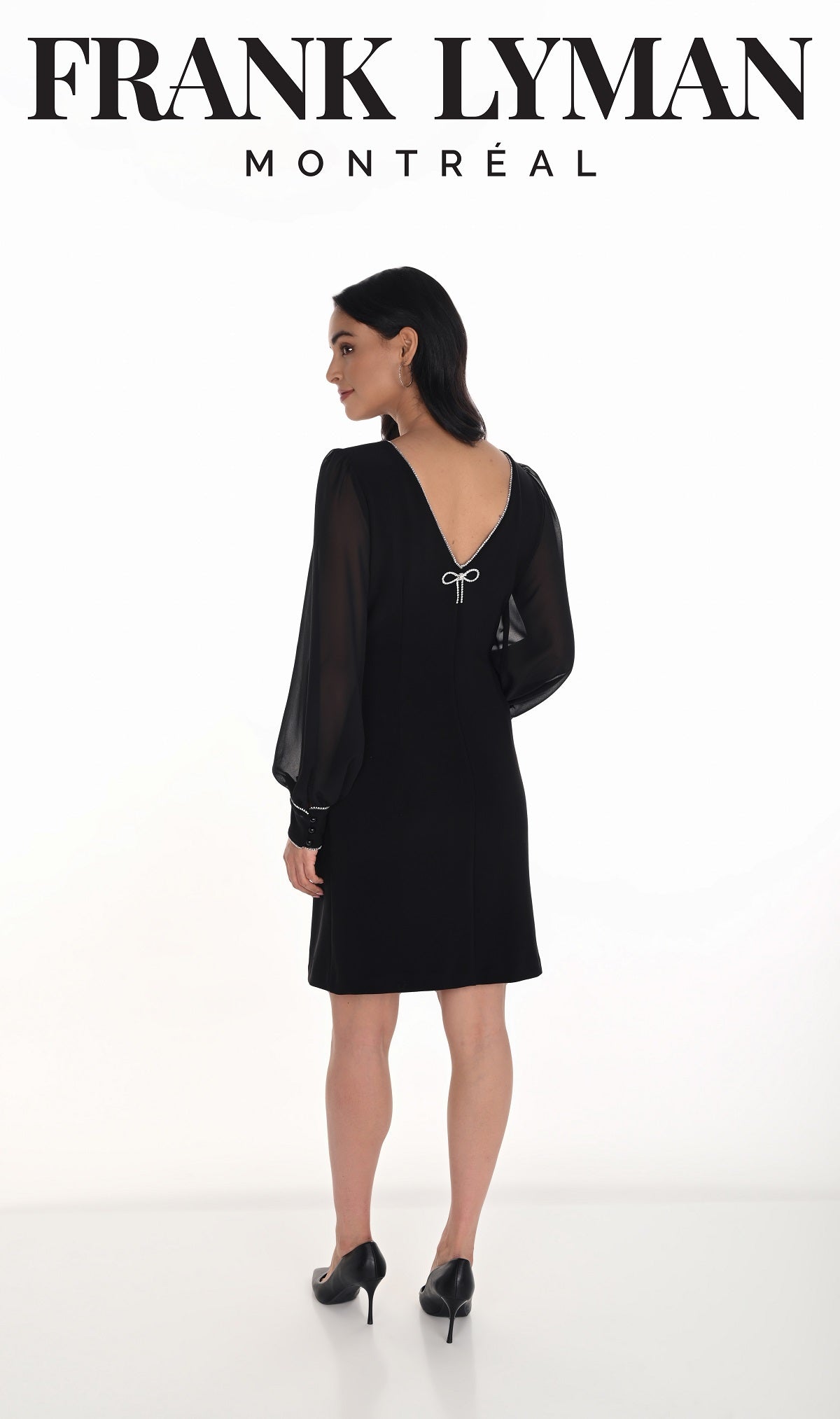 Woman wearing a black dress with sheer sleeves by Frank Lyman Montreal on a white background