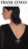 Black dress with a decorative bow detail on the back, worn by a model, with 'Frank Lyman Montreal' branding