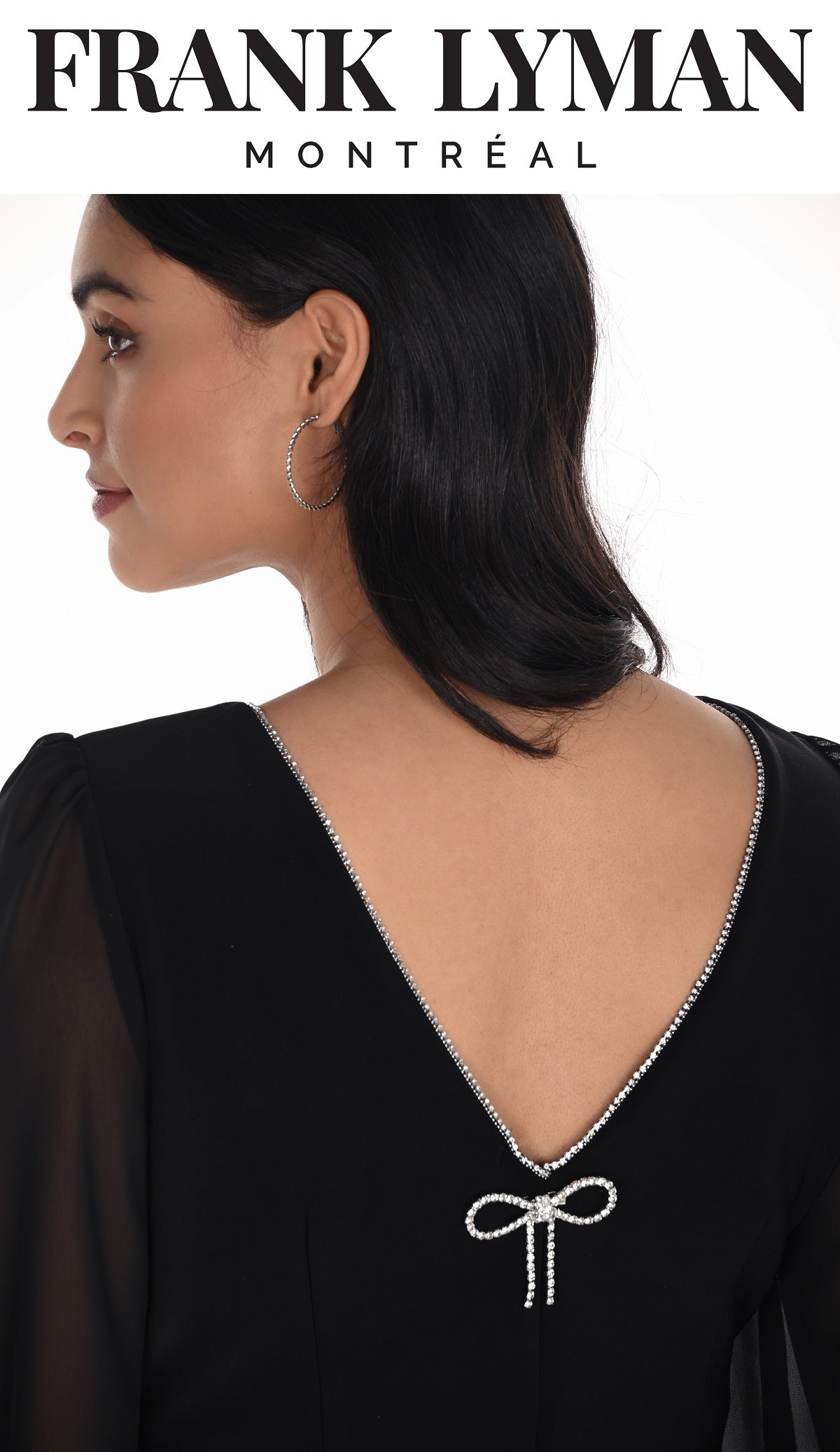 Black dress with a decorative bow detail on the back, worn by a model, with 'Frank Lyman Montreal' branding