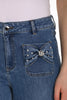 High rise blue jeans with striking crystal stone bow detail in full length with wide leg