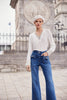 High rise blue jeans with striking crystal stone bow detail in full length with wide leg