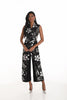 Woman wearing a black floral jumpsuit on a white background
