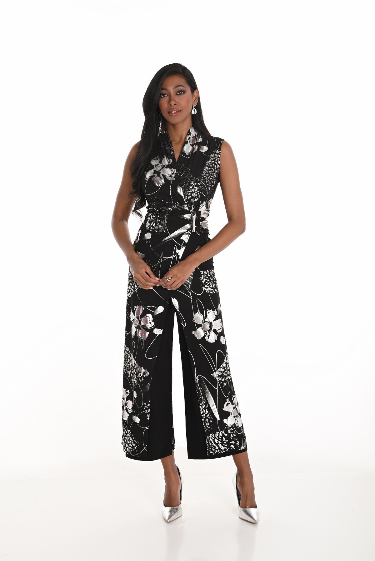 Woman wearing a black floral jumpsuit on a white background