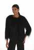 Woman wearing a black textured sweater on a white background