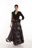Woman wearing a black and purple floral dress on a white background