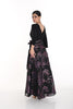 Woman wearing a black and purple floral dress on a white background