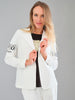 Woman wearing a white blazer with branding on sleeves against a gray background