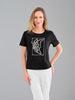 Woman wearing a black t-shirt with a butterfly design on a gray background