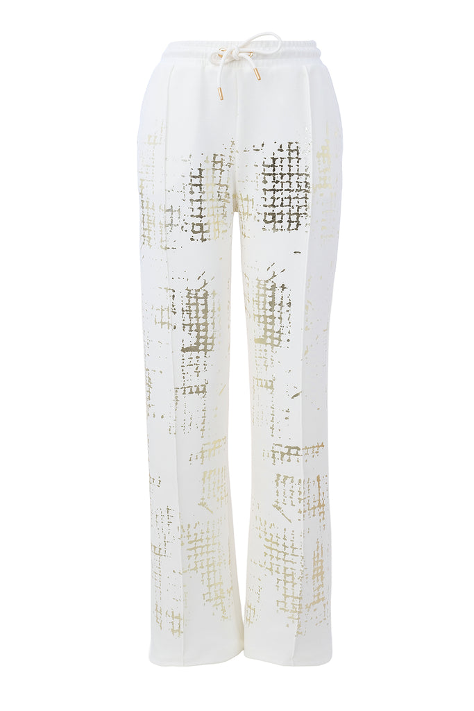 White pants with gold geometric pattern on a white background