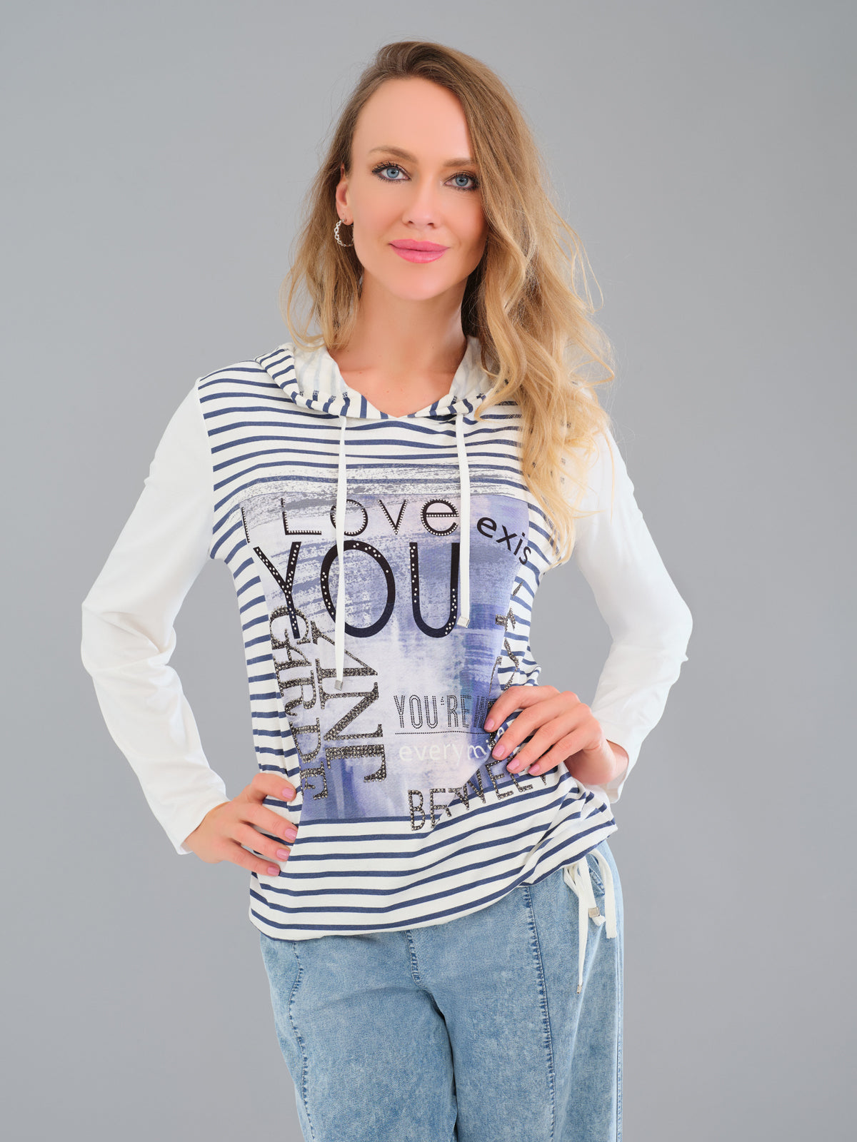 Woman wearing a striped hoodie with text design on a gray background