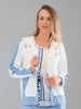 Woman wearing a light blue and white jacket with a brand logo on a gray background