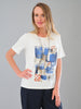 Woman wearing a white t-shirt with abstract blue and red design on a gray background