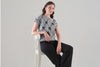 Fashionable cropped length sweater with front bow detail. Tricotto 96210