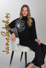 Black sweater with front floral accent detail