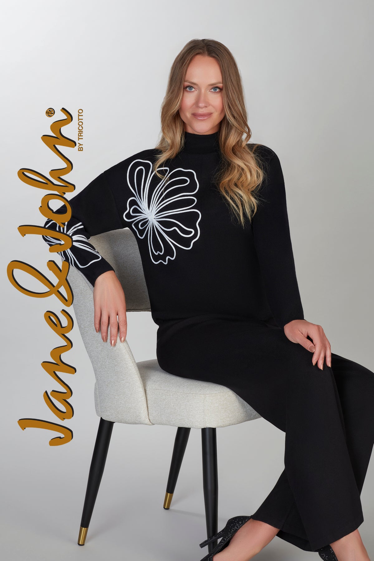 Black sweater with front floral accent detail