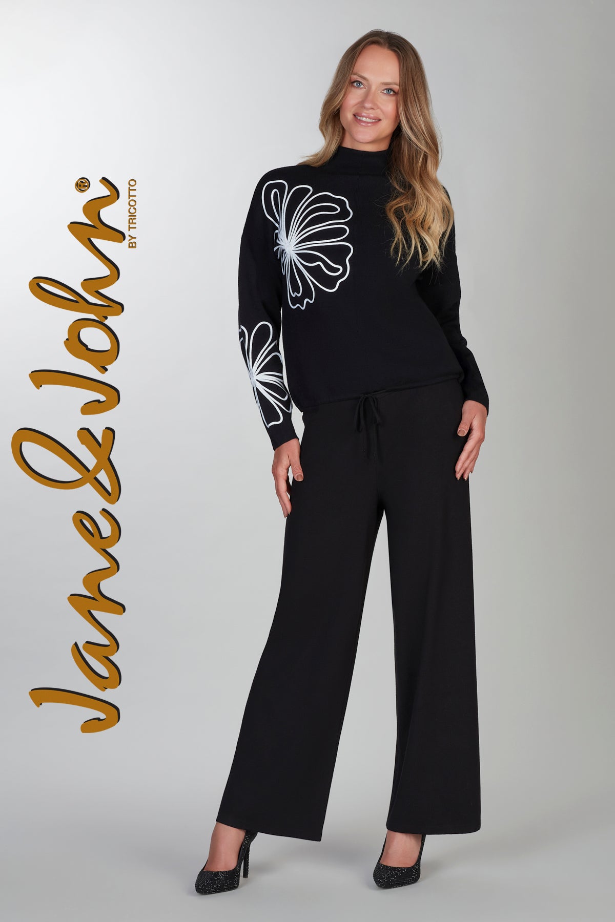 Black sweater with front floral accent detail