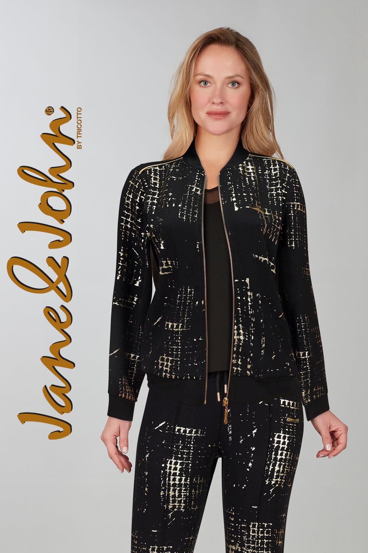 Textured knit bomber relaxed jacket with zip front and pockets. Gold print on front only, back is solid black.