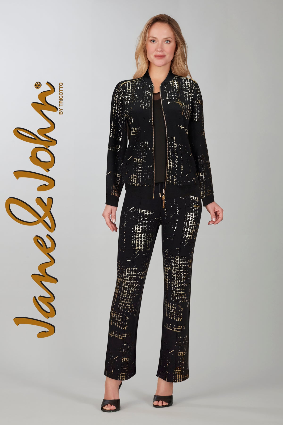Textured knit bomber relaxed jacket with zip front and pockets. Gold print on front only, back is solid black.