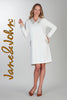 Woman wearing a white dress with decorative elements, standing against a gray background. Brand 'Jane & John' visible.