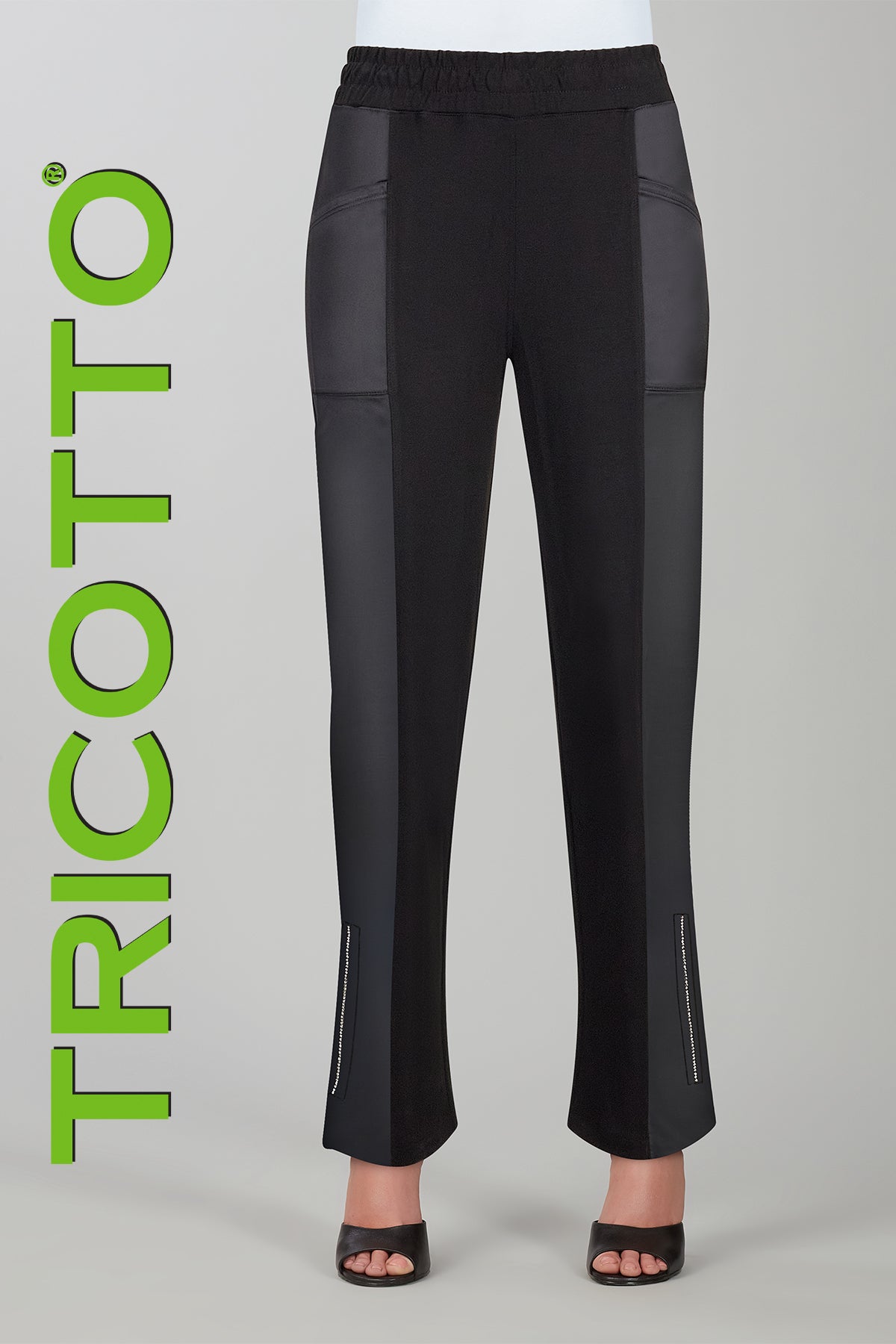 Black pants with gray patches on a gray background, featuring the brand 'Tricotto'.