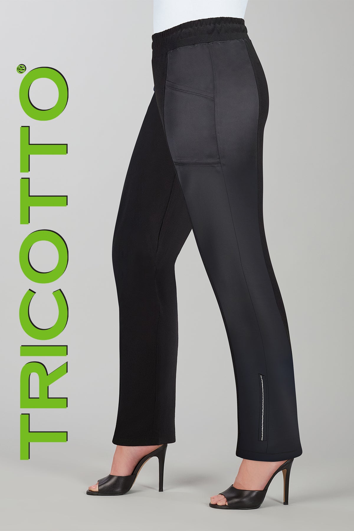 Black pants with gray patches on a gray background, featuring the brand 'Tricotto'.
