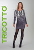 Woman wearing a gray dress with lace details and black tights, standing against a light gray background with 'TRICOTTO' branding.