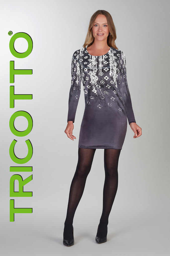 Woman wearing a gray dress with lace details and black tights, standing against a light gray background with 'TRICOTTO' branding.